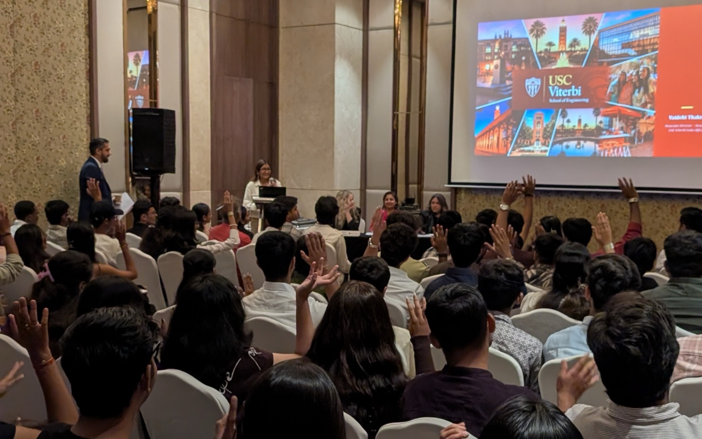 Students raising their hands during a university panel at a SEED recruitment fair